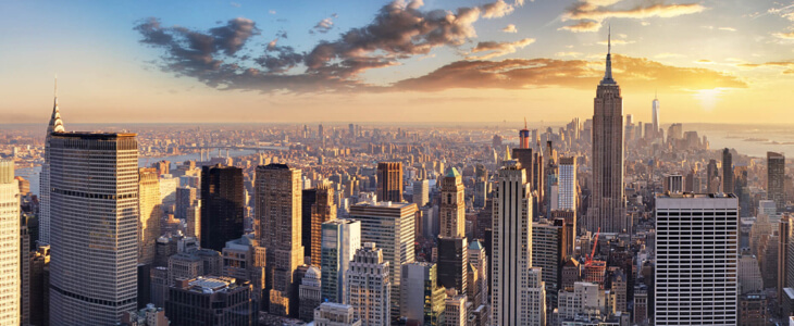 A skyline of NYC with the sun setting